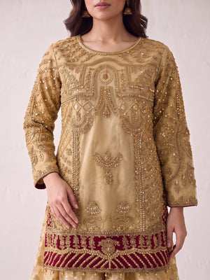 Heavy tilla embroidery close-up on gold net shirt with maroon hem band
