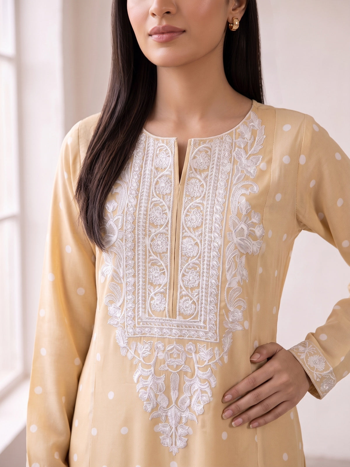 White thread embroidery on cream georgette shirt neckline close-up