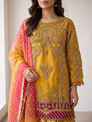 Heavy tilla embroidery close-up on mustard net shirt with magenta hem band