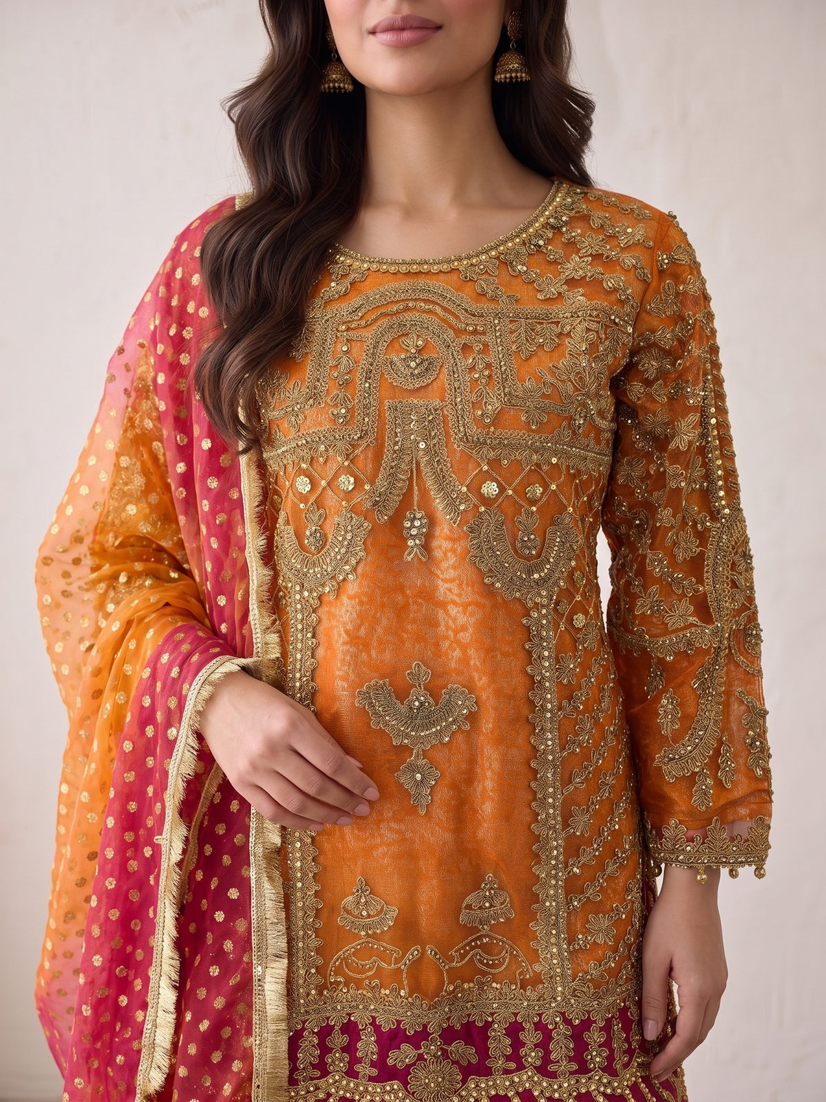 Heavy tilla embroidery close-up on orange net shirt